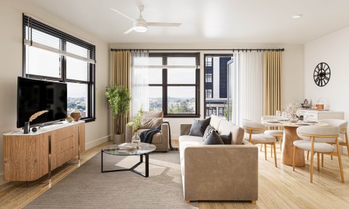 Spacious and well-lit living spaces living room with couch chairs and tv