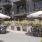 a patio with tables and chairs and umbrellas