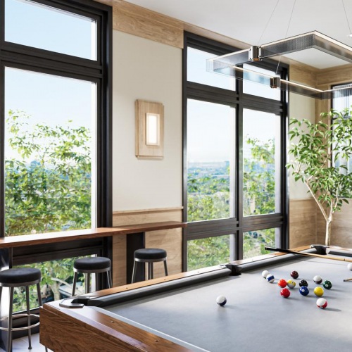Everything within reach a pool table in a room with large windows